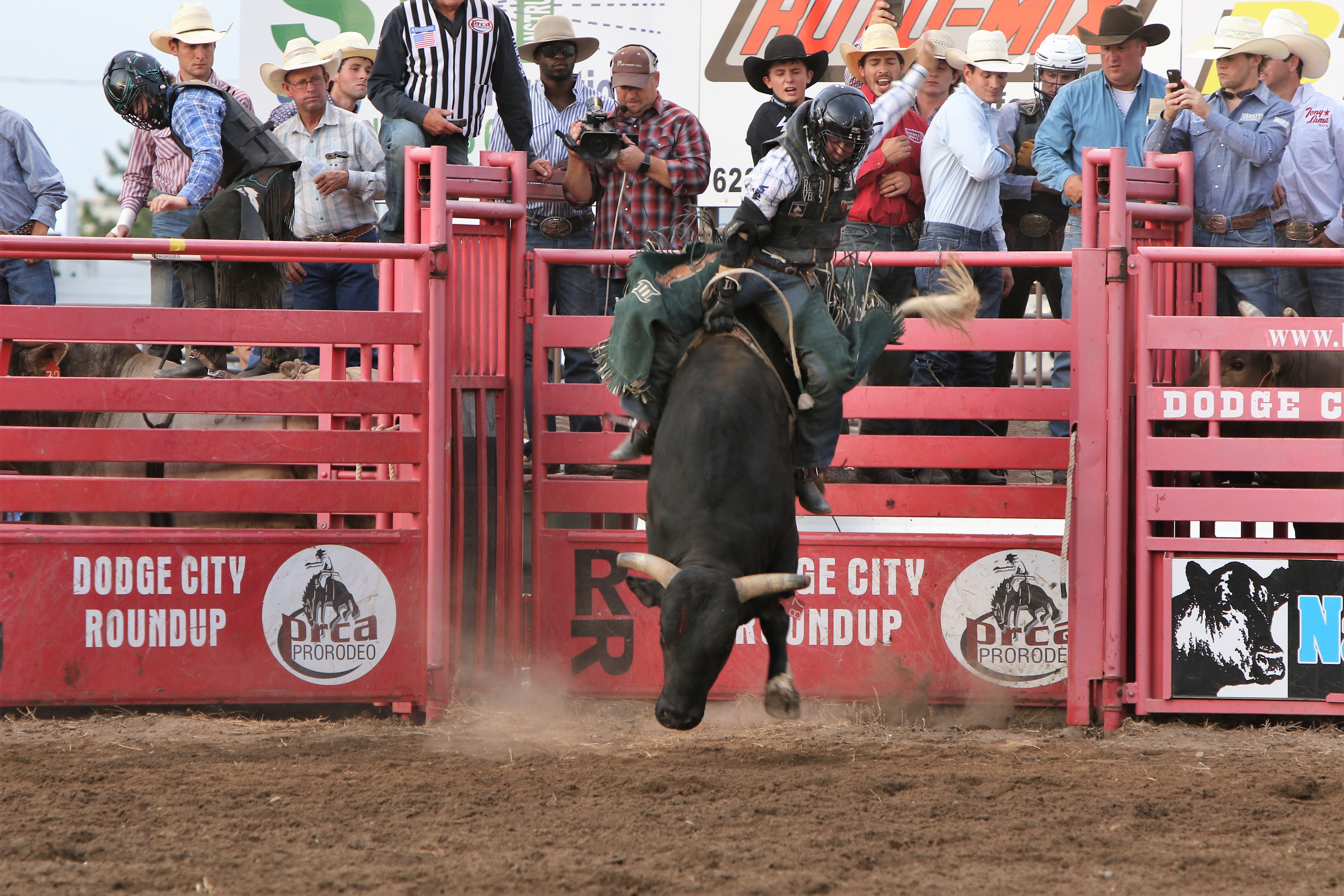 Trey Benton rides Frontier Rodeo's Black Ice for 86.5 points to win the Xtreme Bulls title at Dodge City Roundup Rodeo on Tuesday. (PHOTO BY DAVID SEYMORE)