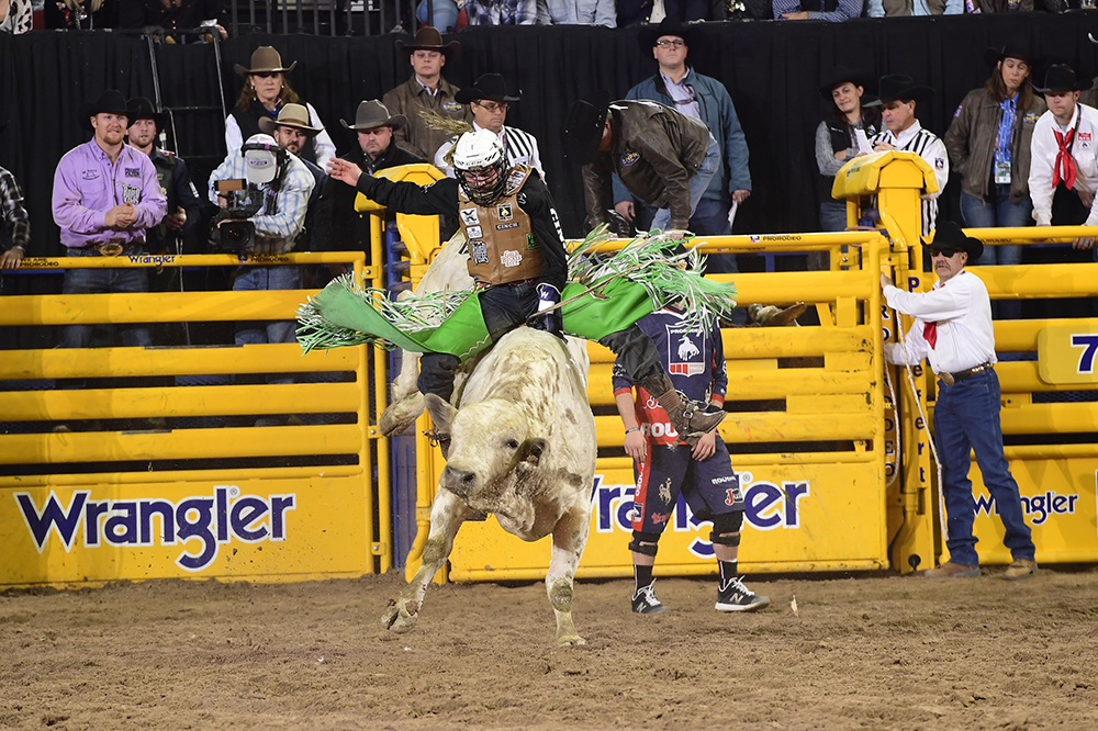 Jordan Spears rode his sixth bull in nine rounds Friday, scoring 85 points on Corey & Lange's Short Bus to finish sixth in the ninth round of the National Finals Rodeo. (PRCA PRORODEO PHOTO BY JAMES PHIFER)