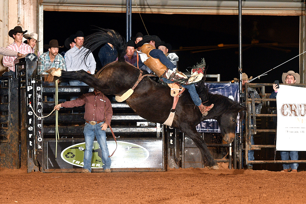 Garrett Shadboldt rides New Frontier Rodeo's Brown Eyed Girl for 83 points Friday night to win the first round of the Chisholm Trail RAM Prairie Circuit Finals Rodeo. He moved into the lead in the circuit standings with the win. (PHOTO BY DALE HIRSCHMAN)