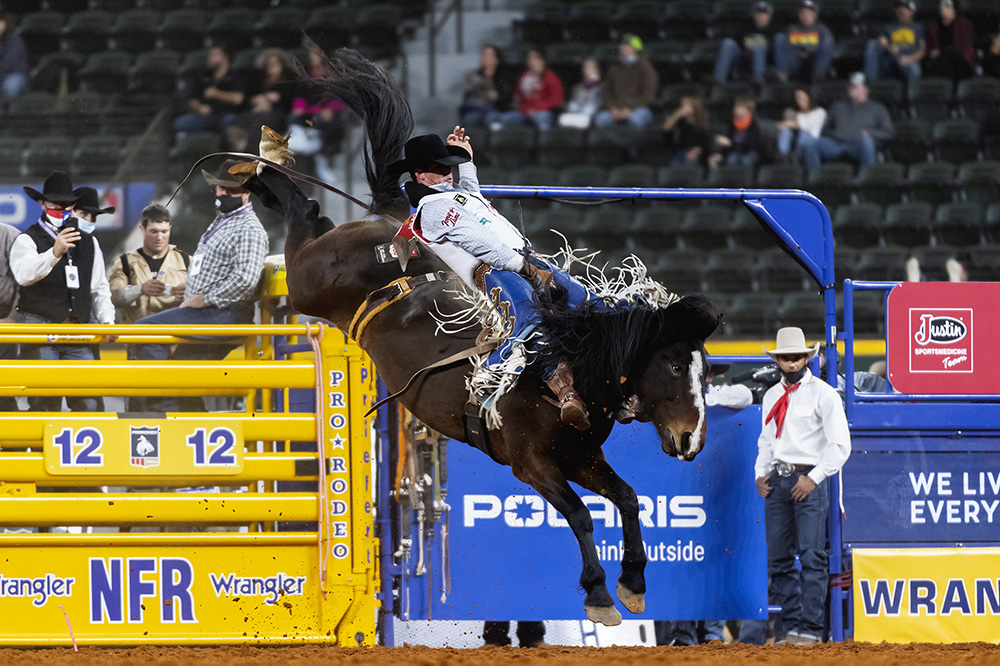 Richmond Champion rides Wayne Vold's True Grit for 85 points to place in Sunday's fourth round of the National Finals Rodeo. (PHOTO BY JAMES PHIFER)