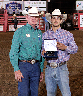 Dodge City Xtreme Bulls champion Elliot Jacoby shows off his trophy spurs, handed to him by Dr. R.C. Trotter, the rodeo committee's president. (PHOTO BY DAVID SEYMORE)