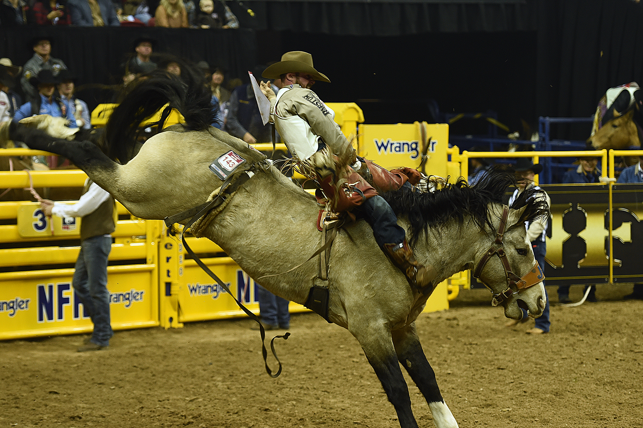 Mason Clements rides J Bar J Rodeo's Colorado Bulldog for 86.5 points Thursday night to finish second in the opening round of the National Finals Rodeo. (PHOTO BY ROBBY FREEMAN)
