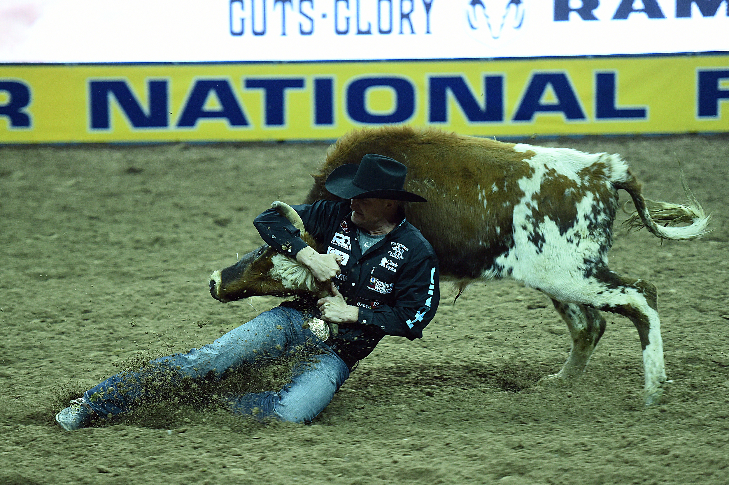 Kyle Irwin wrestled his steer to the ground in 4.0 seconds Thursday night to finish in a tie for third place in the opening round of the National Finals Rodeo. (PHOTO BY ROBBY FREEMAN)