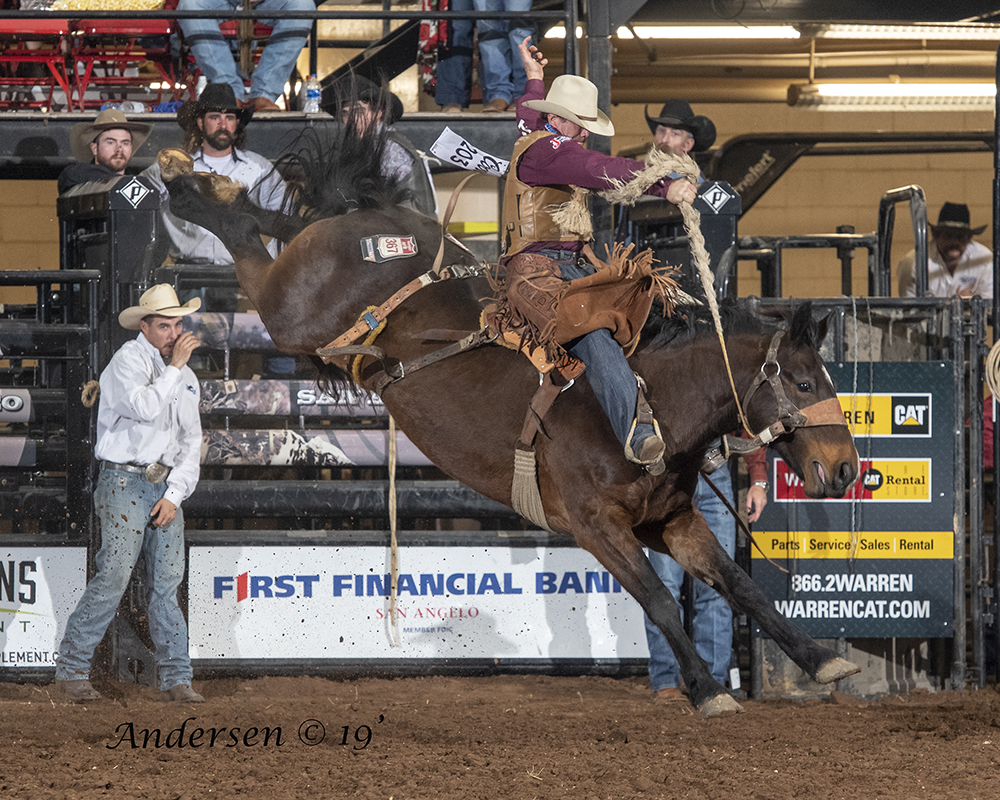 Cody DeMoss rides Lancaster and Jones' Total Equine Angel Fire for 87 points Friday night to take the lead in saddle bronc riding during the first performance of the San Angelo Stock Show and Rodeo. (PHOTO BY RIC ANDERSEN)