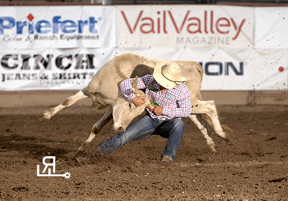 Chisum Docheff wrestles his steer to the ground in 4.4 seconds Thursday night to share the second-round lead at the Eagle County Fair and Rodeo. He placed in the first round and now owns the two-run aggregate lead by seven-tenths of a second. (PHOTO BY ROBBY FREEMAN)