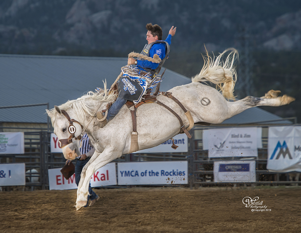 Jake Wright rides Cervi Rodeo's Buckin' Crazy for 83.5 points to take the lead at Rooftop Rodeo on Wednesday night. Shortly after the ride, Wright was kicked in the head and had stitches to repair the gash. (PHOTO BY GREG WESTFALL)