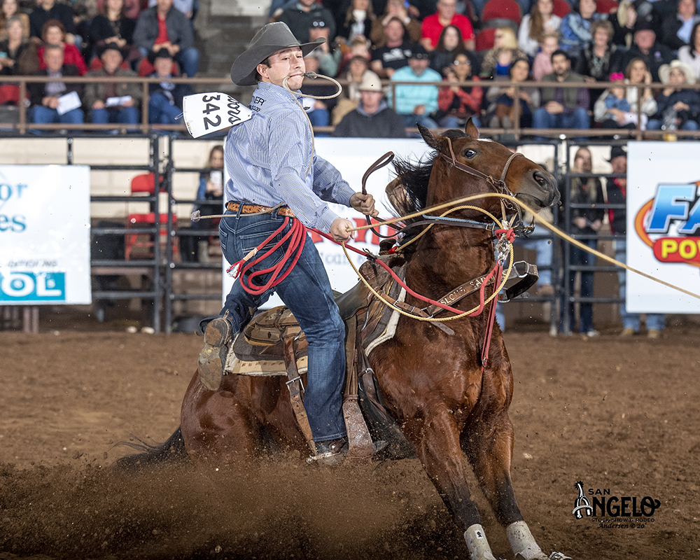 Ty Harris dismounts his horse en route to an 8.8-second run during Friday's second performance of his hometown San Angelo Stock Show and Rodeo. He has roped and tied two calves in a cumulative time of 17.0 seconds to lead tie-down roping. (PHOTO BY RIC ANDERSEN)