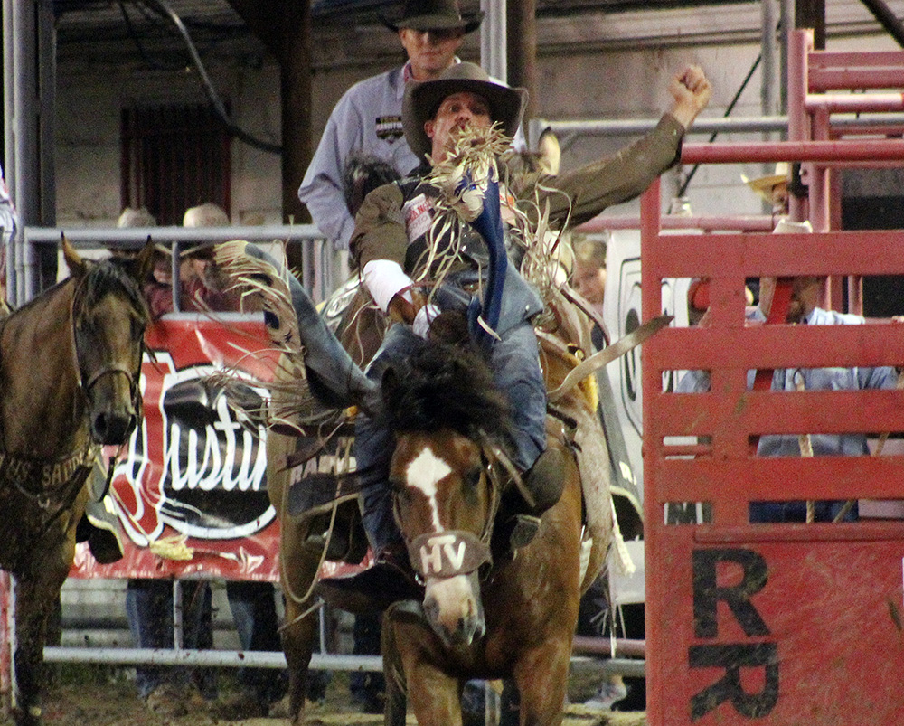 Orin Larsen rides Vold Rodeo's Spicey Chicken for 87 points to take the bareback riding lead after Wednesday's first performance of the Dodge City Roundup Rodeo.