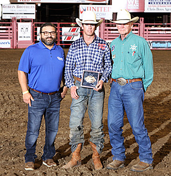 Dodge City Xtreme Bulls champion Trevor Kastner, center, poses with his title buckle with Patrick Falcon and Dr. R.C. Trotter. (PHOTO BY DAVID SEYMORE)