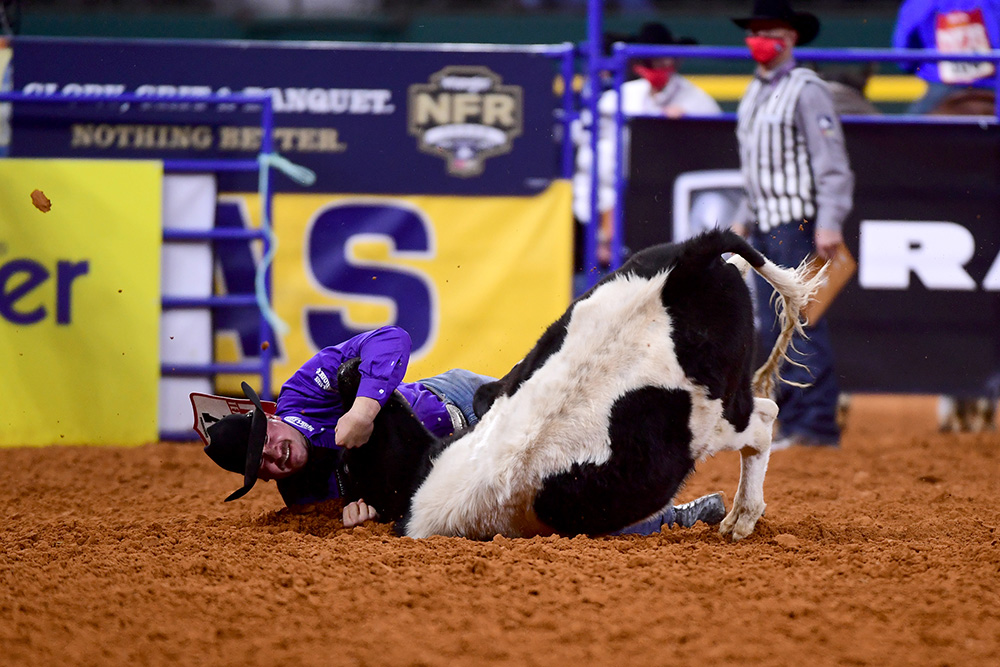 Tanner Brunner drives his steer to the ground during his 3.8-second run to place third in Wednesday's seventh round of the National Finals Rodeo. (PHOTO BY JAMES PHIFER)