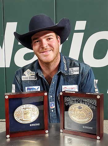 Jacob Edler poses with his average and world championship buckles Saturday night at the National Finals Rodeo. He also won two saddles and nearly $155,000 in 10 nights in Arlington, Texas. 