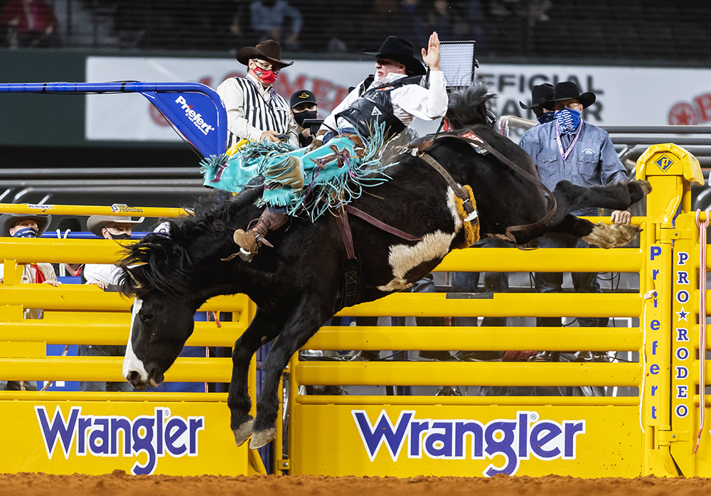 Jess Pope rides Three Hills Rodeo's Devil's Advocate for 85 points to place in Sunday's fourth go-round of the National Finals Rodeo. (PHOTO BY JAMES PHIFER)
